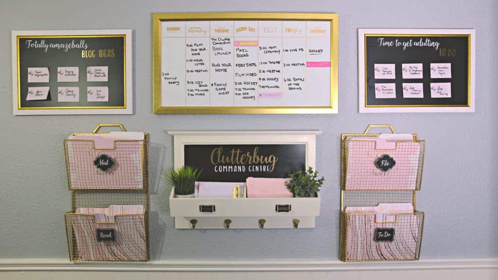 An organized command center tackles paper clutter in Cas' office. Wire storage baskets hold file folders, a whiteboard calendar hangs above. 